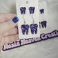 Purple crackle tooth earring set.